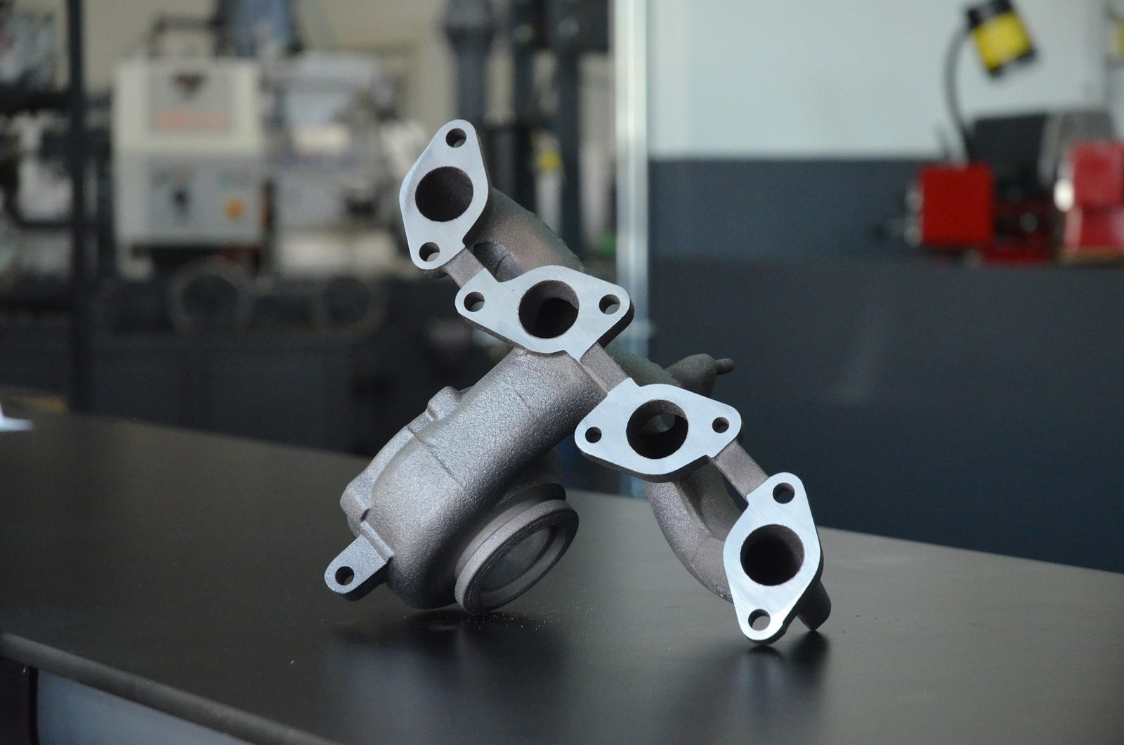 An exhaust manifold, cast and fettled, before machining