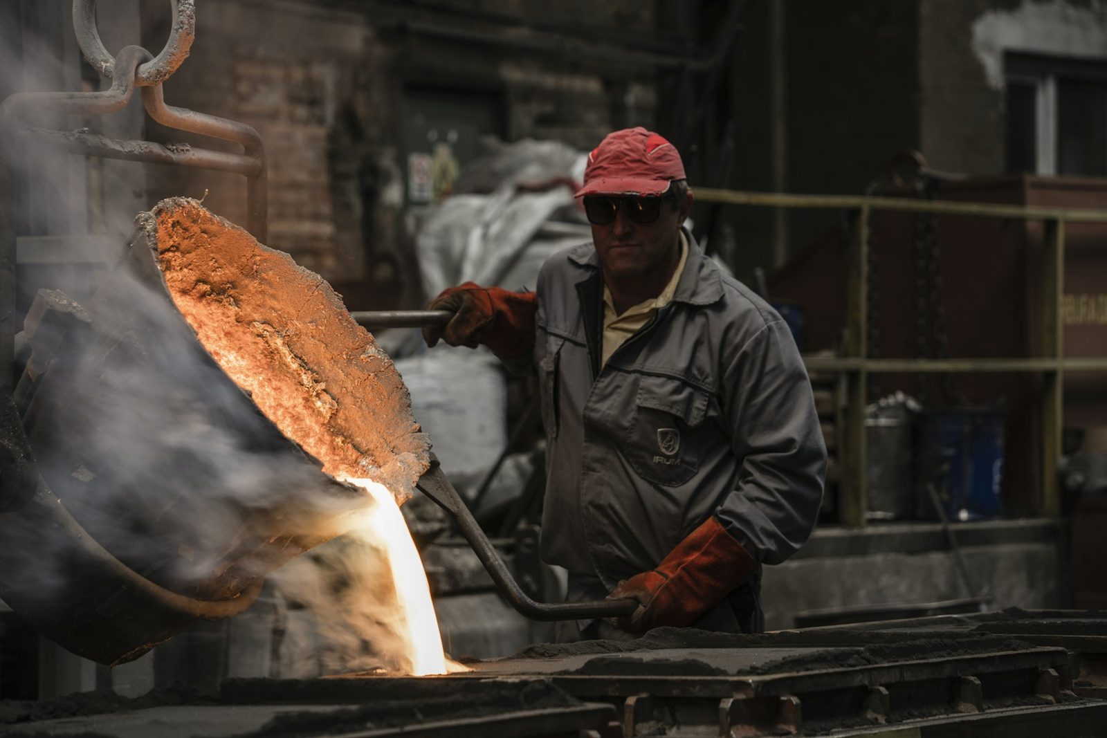 Molten metal poured from a ladle at a foundry