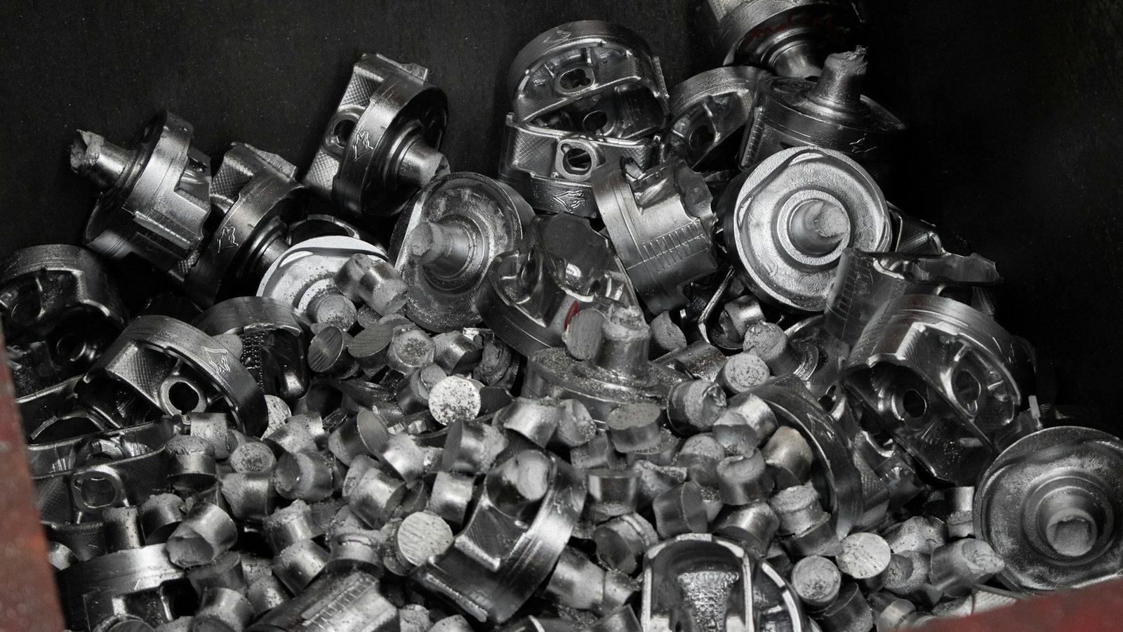 A bin of cast and machined metal parts