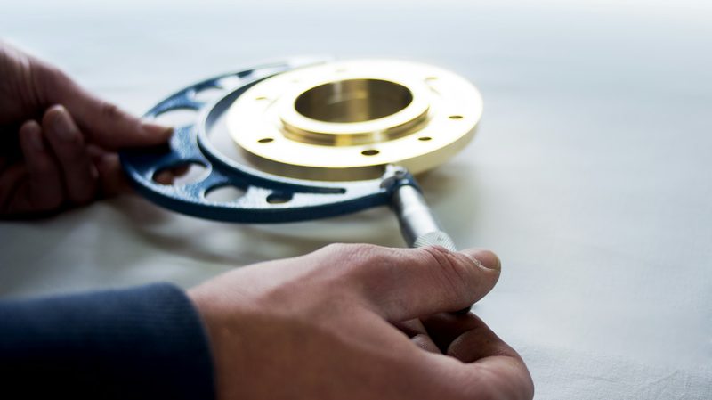 A machined flange measured across its face with a micrometer