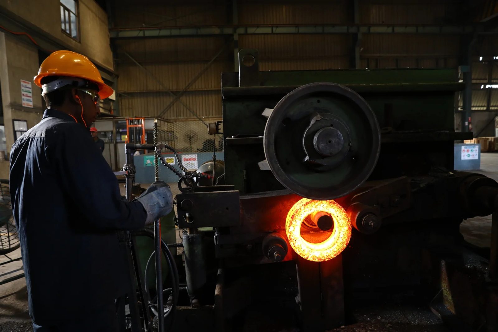 A red hot ring on a machine at a forge shop
