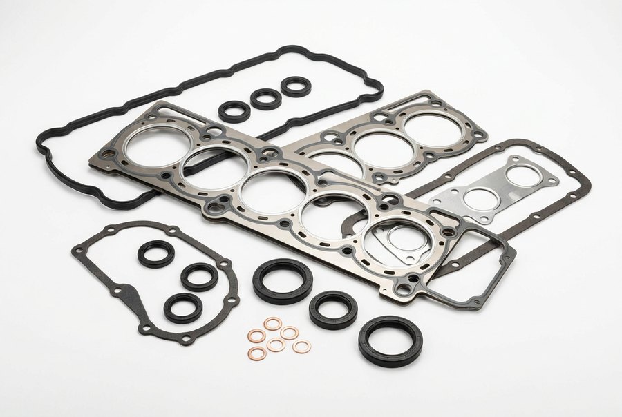 An engine gasket set: a multi layer steel cylinder head gasket, a valve cover gasket, manifold and oil pan gaskets and crankshaft oil seals